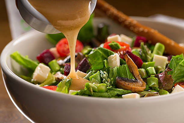 Healthy Organic Salad Organic green salad with lettuce, asparragus, beets, tomato,mushroom, fresh white cheese and vinaigrette dressing. salad dressing photos stock pictures, royalty-free photos & images