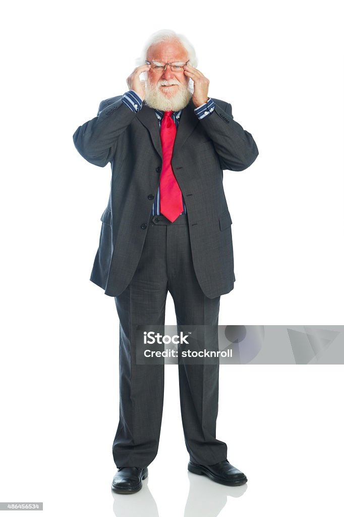 Senior businessman suffering from headache Studio shot of senior businessman suffering from headache over white background Cut Out Stock Photo
