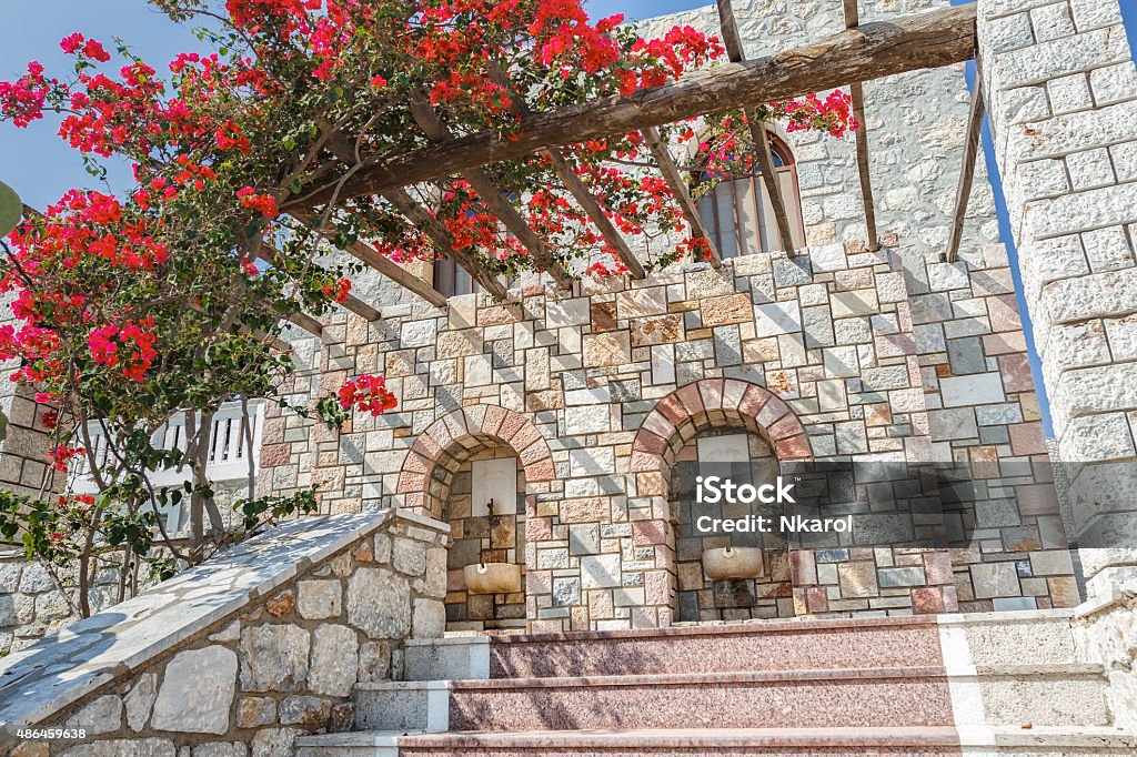 Flowering Bougainvillea on wooden patio pergola on Greek island Kalymnos Flowering Bougainvillea plant on wooden patio pergola on Greek island Kalymnos 2015 Stock Photo