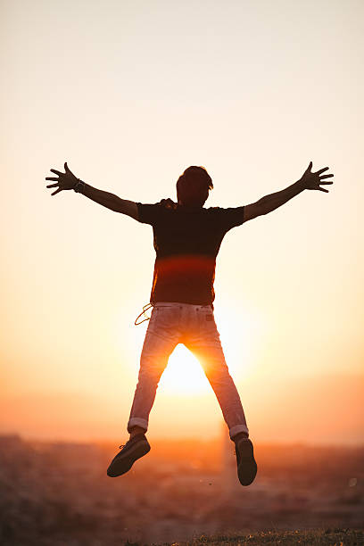 istock Silhouette of man jumping with arm raised 486459666
