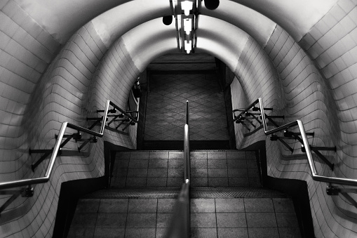 London underground stairs in black and white. can be used for urban lifestyle, travel, and metro themes