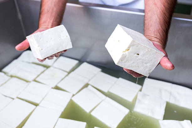 Bulgarian white feta cheese cubes Feta is a brined curd white cheese made in Bulgaria from sheep's milk, or from a mixture of sheep and goat's milk. Similar brined white cheeses produced outside the European Union are often made partly or wholly of cow's milk. feta cheese block stock pictures, royalty-free photos & images