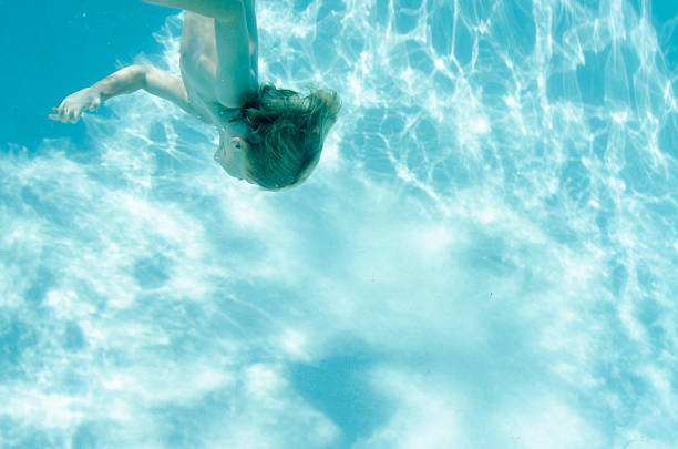 istock Child swimming underwater down towards the bottom 486466214