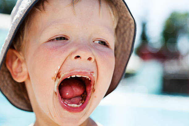 istock Flashy boy with ice cream smeared mouth 486466626
