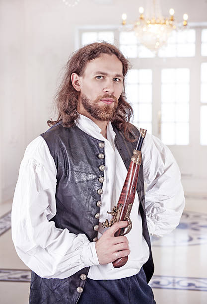 istock Young handsome man in medieval clothes with pistol 486466766