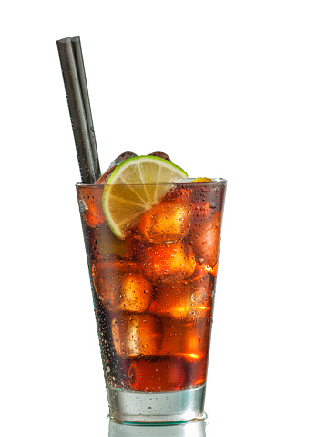 served glass of rum-cola cocktail with ice isolated on white background