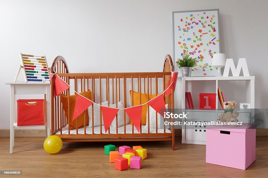 Stylish room for babygirl Photo of stylish room for babygirl with wooden crib 12-17 Months Stock Photo