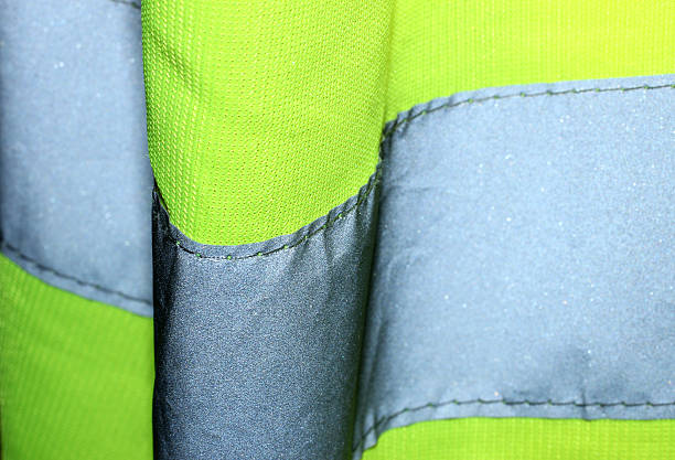 Hi Visibility Jacket Close Up Close up of a yellow hi visibility jacket. reflector stock pictures, royalty-free photos & images