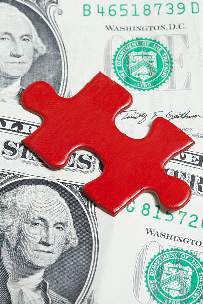 istock Solving the financial puzzle: red jigsaw piece on dollar background 486472361