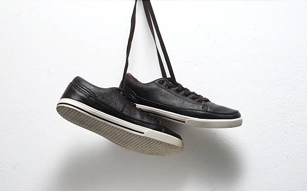 istock shoes hanging from laces 486472860