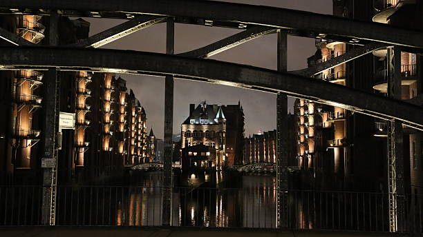 Speicherstadt Hamburg at night, bridge in foreground stock photo