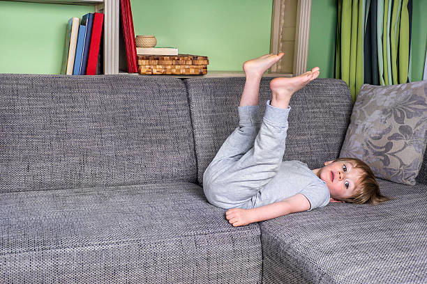istock Little kid hanging around on the couch 486473008
