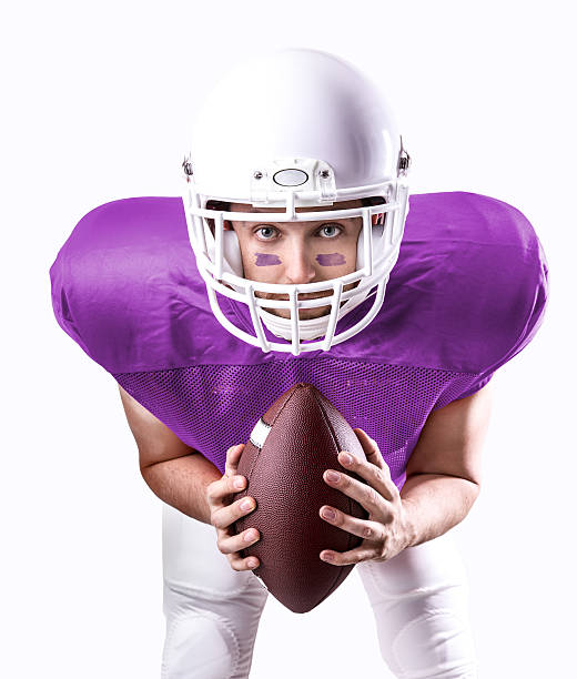 istock Football Player on purple uniform isolated on white background 486473090