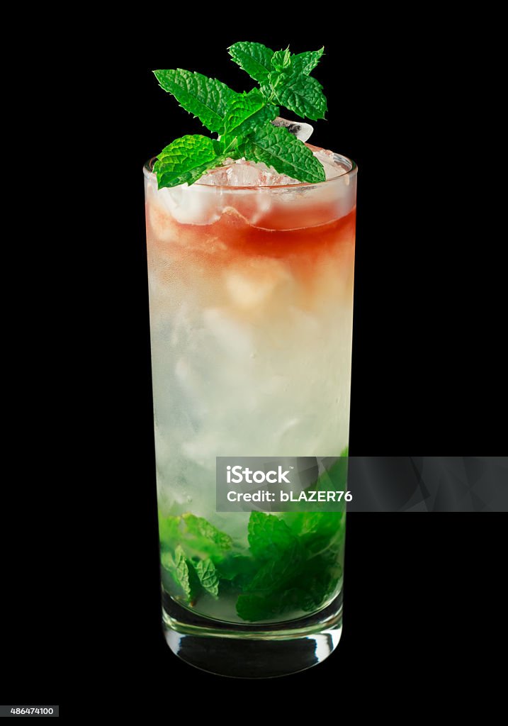 Queens Park Swizzle cocktail on black background Queens Park Swizzle is a classic cocktail from the 1920's that contains rum, lime juice, mint, simple syrup, sugar and bitters. Isolated on black. 2015 Stock Photo