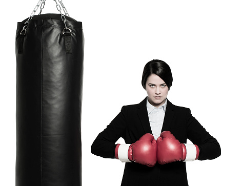 Fight for great business. Businessman wearing a suit and tie with red boxing gloves. White background.