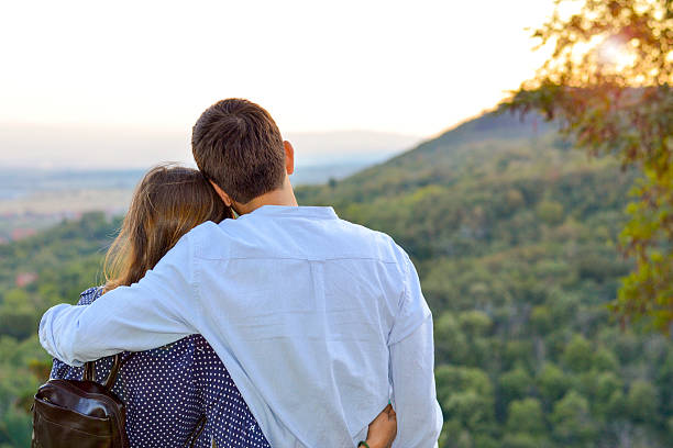 istock Loving couple hugging outdoors with the look at the sunset. 486474636