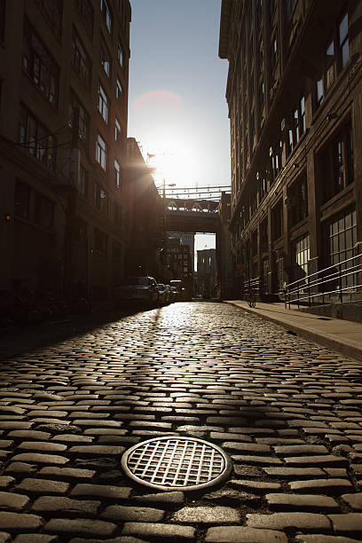 istock Deserted Brooklyn DUMBO Cobblestone Backstreet Sunset Lens Flare 486476699
