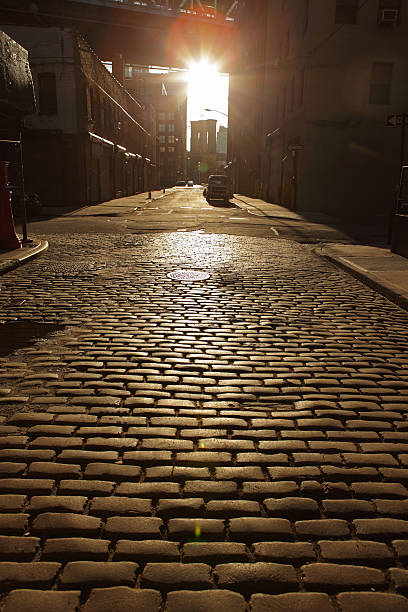 istock Deserted Brooklyn DUMBO Cobblestone Backstreet Sunset Lens Flare 486476711