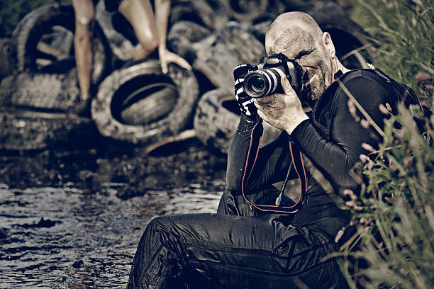 istock photographer working in dirty water 486480426