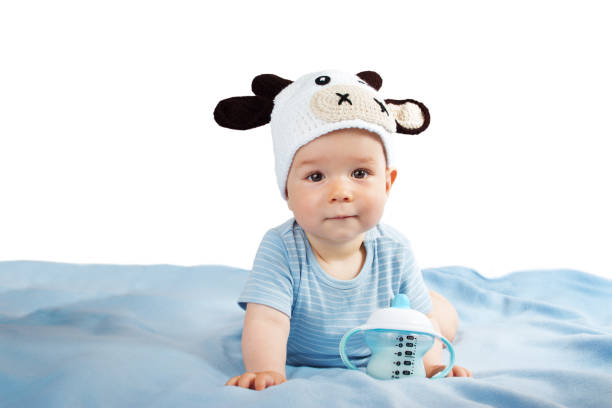 istock Baby in a cow hat drinking milk 486480770