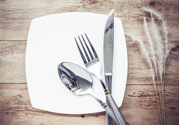 istock Plates and cutlery on a wooden table 486481488
