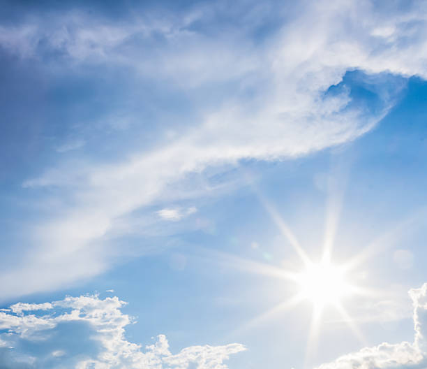 istock natural lens flare and radiating rays  blue sky with clouds 486481658
