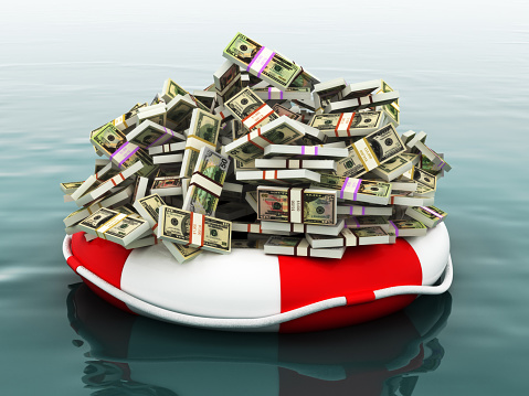 Large pile of money floating on a life preserver.