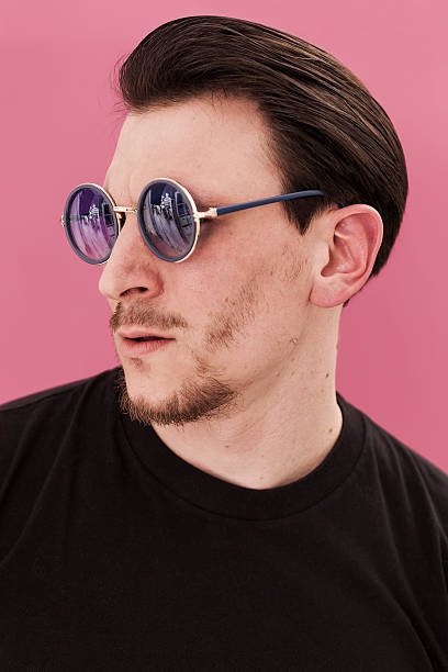 istock Handsome man portrait looking aside while wearing blue sunglasse 486484356