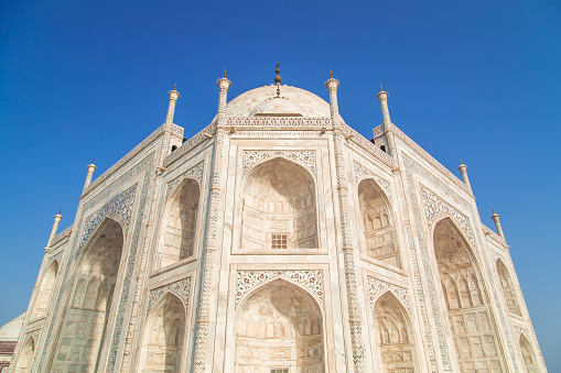 Top view of South-East side of Taj Mahal on blue sky.