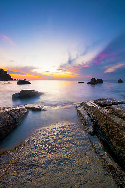 istock Sunrise at rocky tropical beach. 486489862