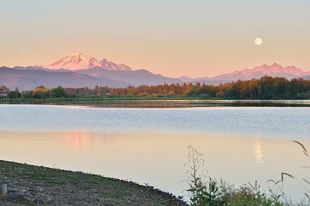 Full Blue Moon over Mt. Baker and Three Sisters Mountain Full Blue Moon over Mt. Baker and Three Sisters Mountain, from Wiser Lake, Washington mt baker stock pictures, royalty-free photos & images