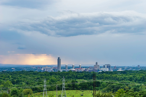 Stormy skyline of Albany, capital of the state of New York and seat of Albany County, USA, with rain falling in the distance, on a summer evening