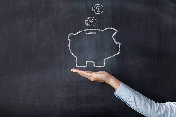 istock Chalkboard with hand and piggy bank 486500428