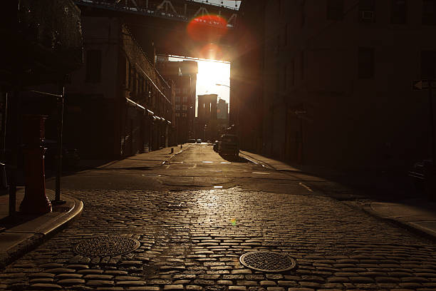 istock Deserted Brooklyn DUMBO Cobblestone Backstreet Sunset Lens Flare 486500529
