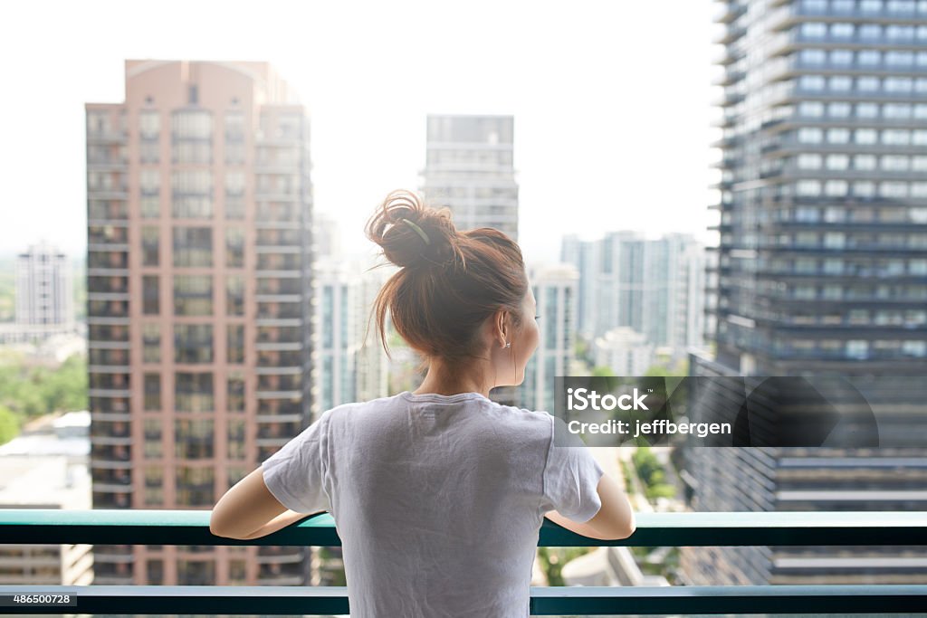 This city looks so pretty... A young woman standing on a balcony in the cityhttp://195.154.178.81/DATA/i_collage/pu/shoots/805445.jpg Apartment Stock Photo