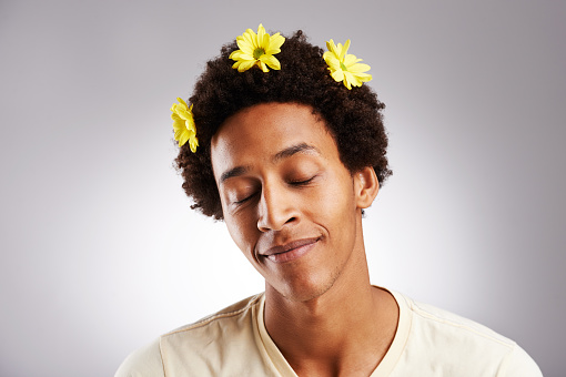 Cropped shot of a young man with flowers in his hair over a grey backgroundhttp://195.154.178.81/DATA/i_collage/pu/shoots/805485.jpg