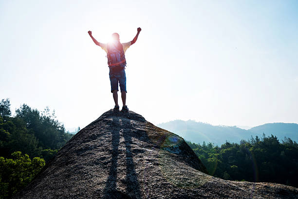 istock Man success standing at mountain peak 486501360