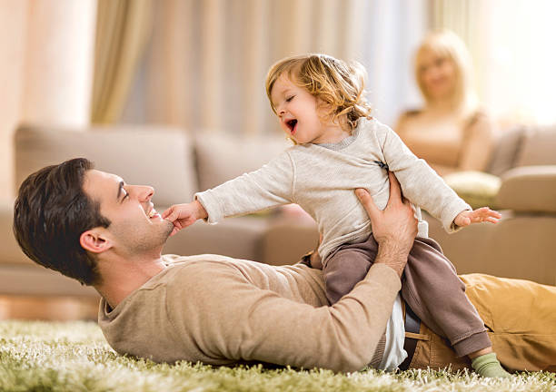 istock Cheerful father and son playing at home. 486501794