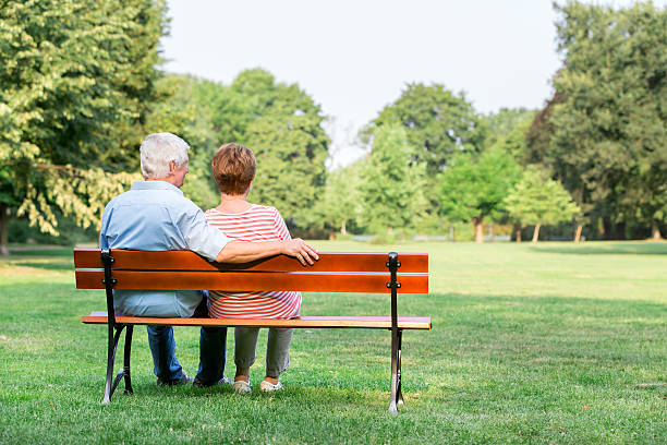 istock Senior adults outdoors in the park on park bench 486501880