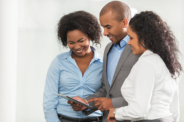 istock Smiling African American business colleagues using touchpad together. 486502002