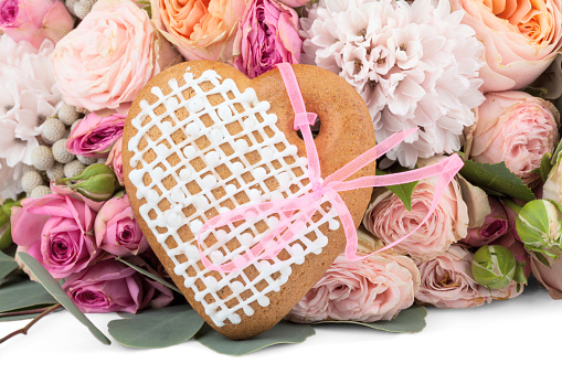 Ginger heart-shaped cookie with lots of flowers isolated on white background