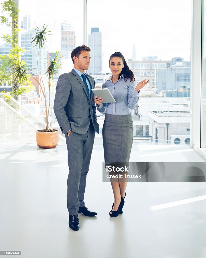 Business couple Full lenght portrait of two business people discussing in the office.  Real Estate Agent Stock Photo