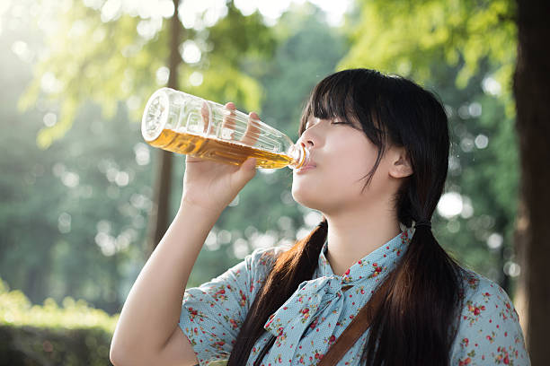 Asian girl drinking beverage stock photo