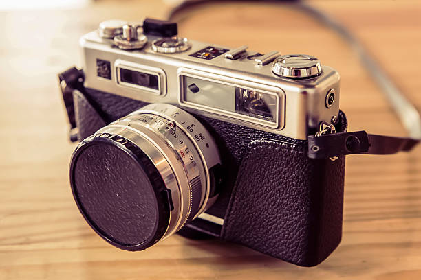 istock Vintage camera on wooden background 486505690