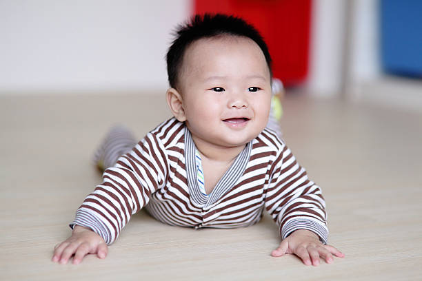 istock Cute Baby crawling on livingroom floor 486505747