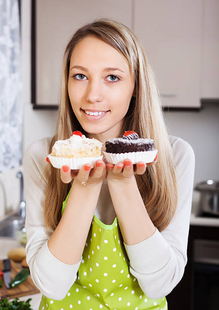 istock Smiling woman in apron with cakes 486505797