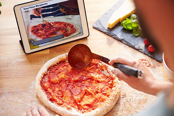 istock Person Following Pizza Recipe Using App On Digital Tablet 486506130
