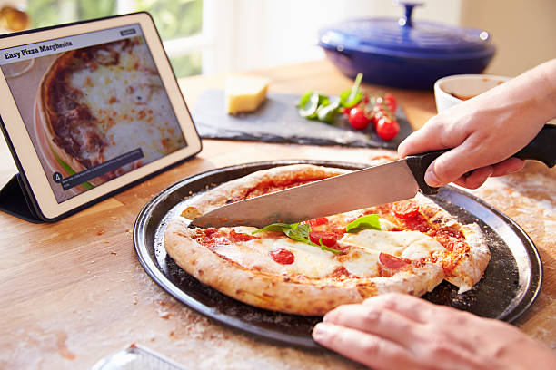 istock Person Following Pizza Recipe Using App On Digital Tablet 486506230