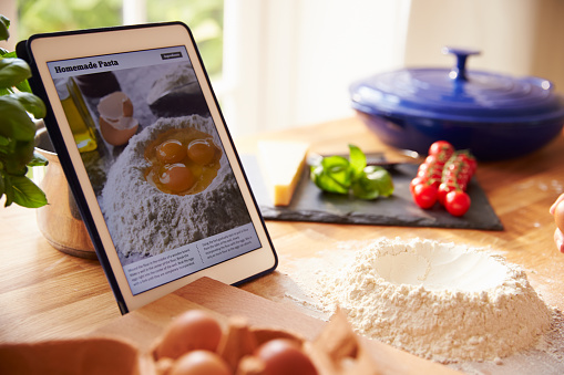 Following Pasta Recipe Using App On Digital Tablet