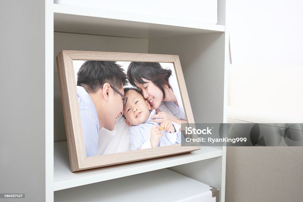 Happy Family photo Happy Family photo on white bookshelf at home Adult Stock Photo